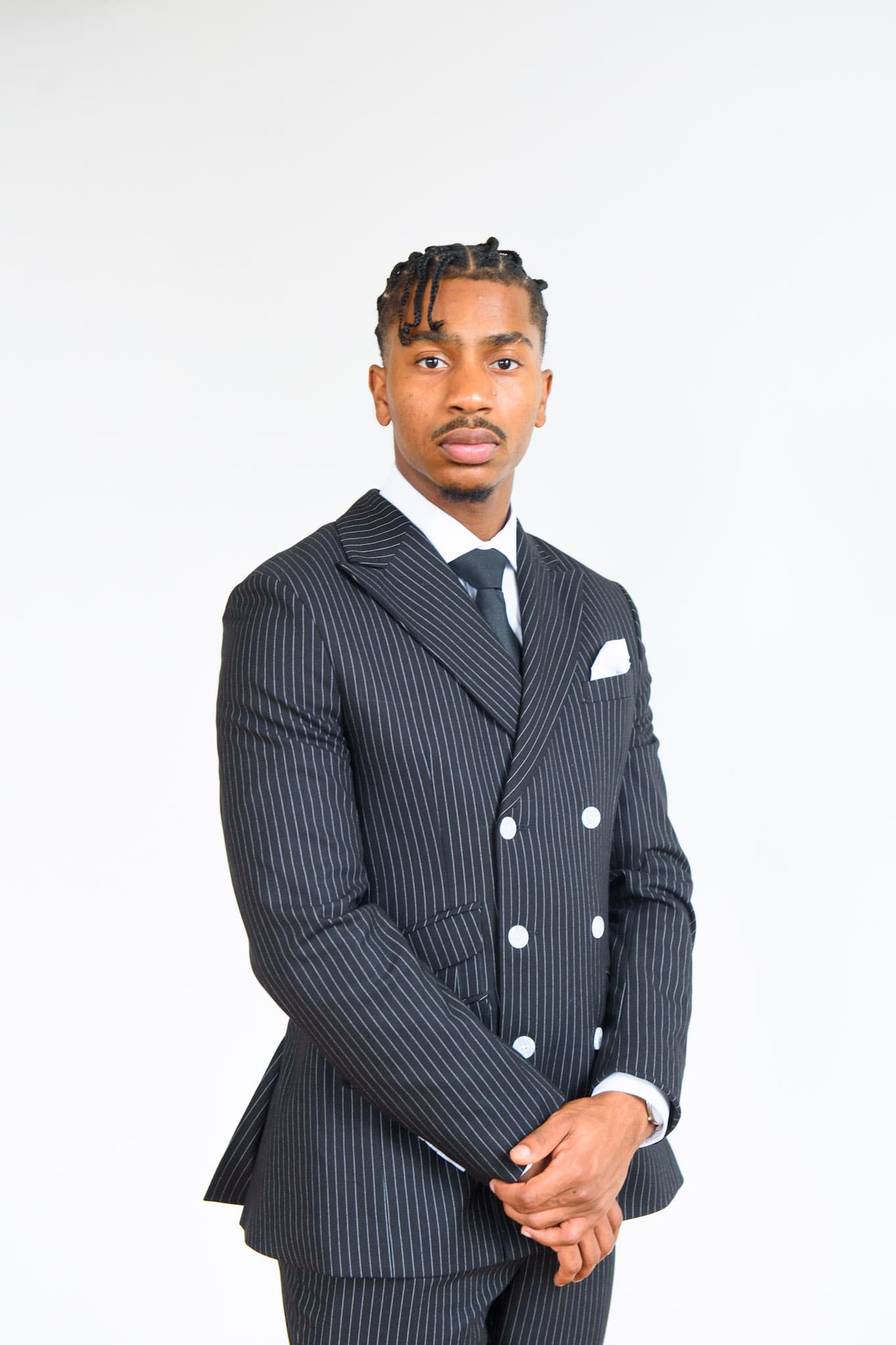 Reginald Key'Shawn Billups in a pinstripe suit.